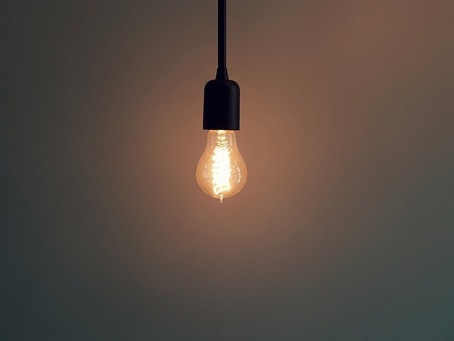 single lightbulb hanging from ceiling