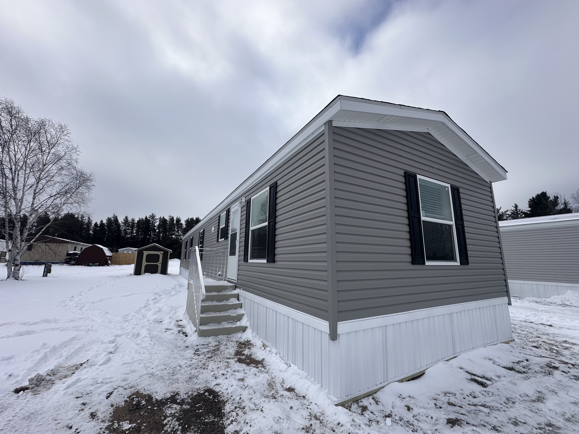 EXTERIOR MOBILE HOME GREY AND WHITE WITH STEPS GWINN MI